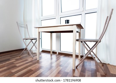 bright interior with empty windows, table and two chairs