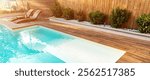 Bright and inviting swimming pool with wooden deck, cozy sun loungers, and lush greenery creating a serene outdoor retreat