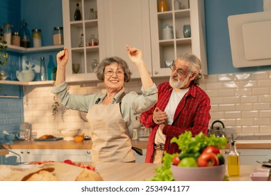 in bright kitchen an elderly man in a red shirt smiling from behind before cooking ties an apron for his wife a happy couple - Powered by Shutterstock