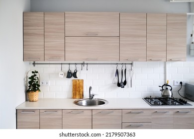 Bright Kitchen Set With Stainless Steel Sink And Facades With Wood Texture