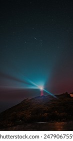 Bright light breaks through dark clouds over a mountain