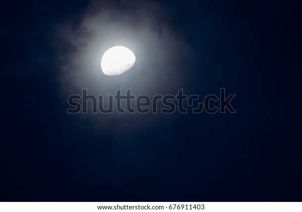 Bright light moon\
over in the cloud at night time beautiful,Suitable for design\
background events and festivals\
