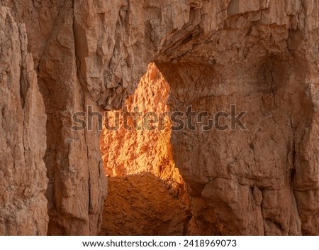Bright Light Shines Through A Tunnel In A Hoodoo in Bryce Canyon
