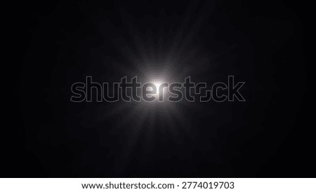 A bright light source against a black background, with a lens flare effect, creating a sense of mystery and wonder.