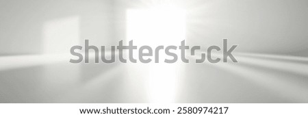 Bright light streaming through an open door in a minimalist white room.