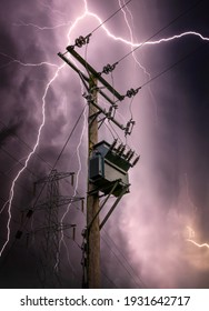 Bright lightning bolts striking electric power pylon tower cables and sub station strike. Electricity discharge cloud to ground storm with transformer on wooden telegraph pole silhouette against sky.