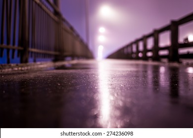 The Bright Lights Of The City At Night, Walk Across The Bridge. View From Ground Level, In Blue Tones