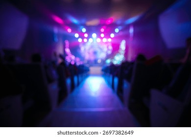 Bright lights create a dynamic atmosphere in a crowded venue where people are enjoying a concert. The excitement fills the air as the performance captivates the audience.