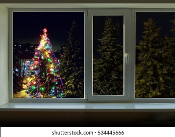 Bright Lights On The Christmas Tree Outside The Window