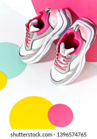 Bright Lit Scene With Chunky Sneakers And Huge Confetti. Colorful Casual Wear Or Footwear. Minimalist Fashion Fitness Creative Concept.