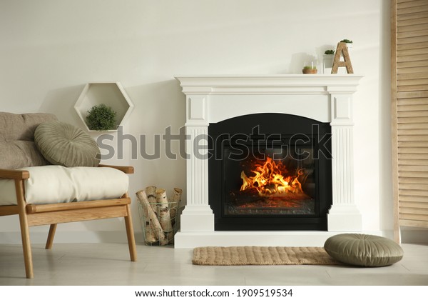 Bright living room interior with fireplace and\
basket of firewood