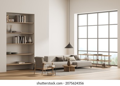 Bright living room interior with large sofa, armchair, panoramic window, bookshelves, carpet and oak wooden floor. Concept of minimalist design. Comfortable place for meeting. 3d rendering
