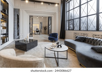 bright luxurious expansive interior of country chalet with stunning views of winter forest through panoramic windows white walls with ornaments, fireplace, work and sitting area without people daytime - Powered by Shutterstock