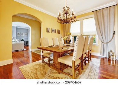 Bright Luxury Dining Room With Rich Carved Wood Table