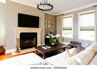 Bright Luxury Living Room  With Sofa, Black Coffee Table, Fireplace And Tv