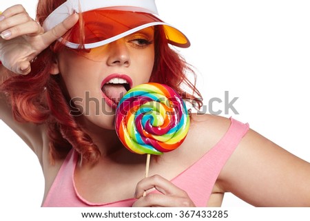 Bright makeup. Beauty Girl Portrait holding Colorful lollipop. Pink Lips. Nail polish manicured nails. 