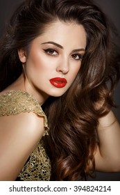 Bright makeup woman red lips fashion model with long brunette hair, sexy girl vogue style, Arabian beauty woman face closeup Indian lady with dark long curly hair and long lashes isolated in studio