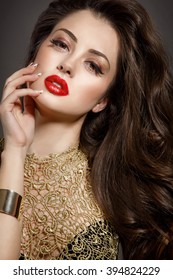 Bright makeup woman red lips fashion model with long brunette hair, sexy girl vogue style, Arabian beauty woman face closeup Indian lady with dark long curly hair and long lashes isolated in studio