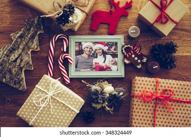 Bright Memories. Top View Of Christmas Decorations And Photograph In Picture Frame Laying On The Rustic Wooden Grain 