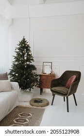 Bright Modern Interior Design Living Room With Christmas, New Year Decorations, Fir Tree, Comfortable Sofa, Lounge Chair, Carpet, Furniture. Aesthetic Winter Holidays Celebration Composition