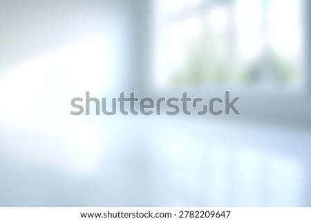 A bright modern interior space with large windows allowing natural sunlight to flood the room, creating an airy, minimalist environment suitable for multiple uses.