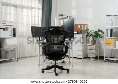 A bright, modern office setup featuring a computer desk with two screens, an ergonomic chair, storage units, and a potted plant, ideal for a professional work environment.