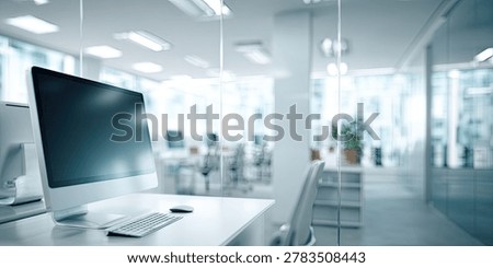 A bright and modern office space with a computer, keyboard, and monitor on a clean desk, showcasing a contemporary work environment.