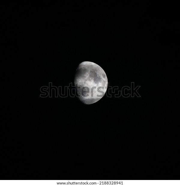 Bright moon in a clear black\
sky