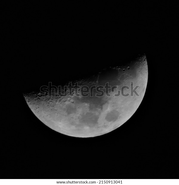 bright moon craters dark\
black sky 