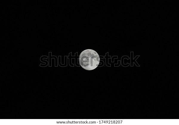 bright moon in dark\
sky