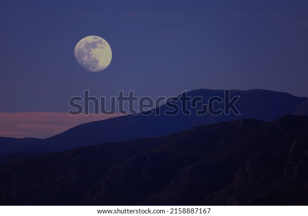 Bright moon and mountain range\
