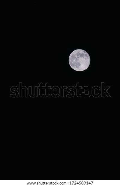 Bright moon on a black\
background sky.