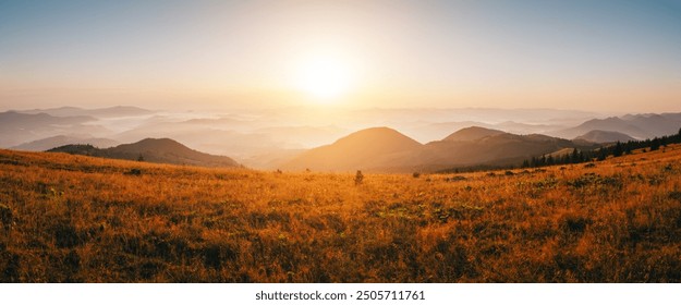 The bright morning sun rises above the horizon of distant mountain ranges. Location place Carpathians, Ukraine, Europe. Tranquil sunshine vibe. Photo wallpapers. Discovery the beauty of earth. - Powered by Shutterstock