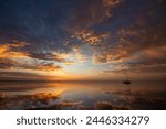 Bright morning sunrise with sailboat in view