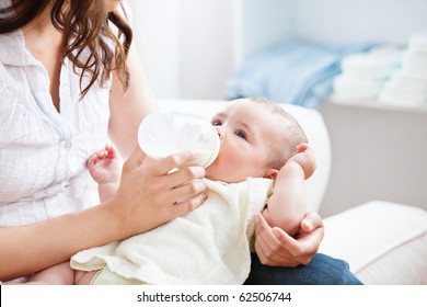 Bright mother feeding her adorable son in the kitchen at home - Powered by Shutterstock