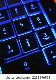 Bright multicolored backlit computer keyboard close-up on the table. Computer keyboard.