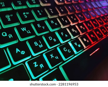 Bright multicolored backlit computer keyboard close-up on the table. Computer keyboard.