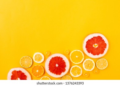 Bright Multicolored Citrus Fruits On A Yellow Background, Summer Flat Lay Concept. Top View, Flatlay With Copy Space