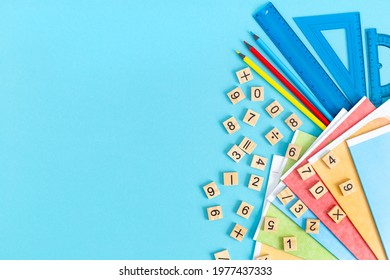 Bright multicolored school supplies, stationery on a blue background. Flat lay.