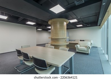 Bright Office Meeting Room With Gray Floor Covering And Beige Furniture.