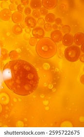 Bright orange bubbles float within a smooth, glossy liquid, creating an abstract background full of energy and texture perfect for various applications.
