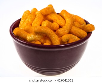 Bright Orange Cheese Puffs In A Red Bowl.