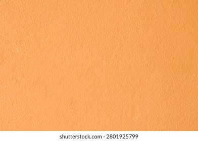 Bright orange colored plaster surface for energetic commercial backdrop designs.