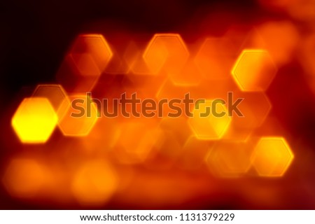 Bright orange flat hexagone lights bokeh on black background
