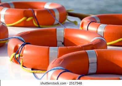 Bright orange life rings lay on top of a boat. safety, danger, rescue, security