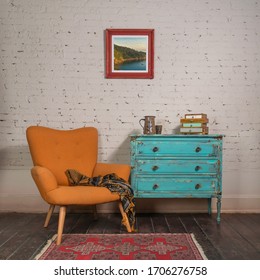 Bright Orange Retro Armchair With Plaid Against White Brick Wall With Shabby Chic Vintage Turquoise Cabinet In Living Room And Hanged Painting, With Clipping Path For The Painting