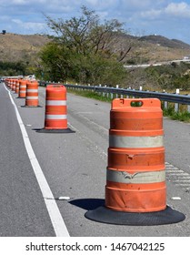 Bright Orange Road Traffic Cones Demarcating A Work Zone On The Freeway.