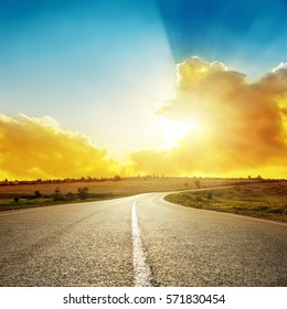 Bright Orange Sunset Over Asphalt Road