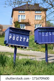 Bright Outdoor Cluster Mail Boxes With Individual Slots In Rural Poland. The Text In Polish On The Mailbox Translates To: 'The Post Office Of Poland'                               