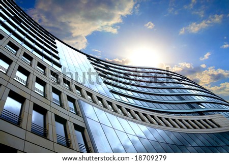 Bright outlook for business. Modern office block with sunny beautiful sky.